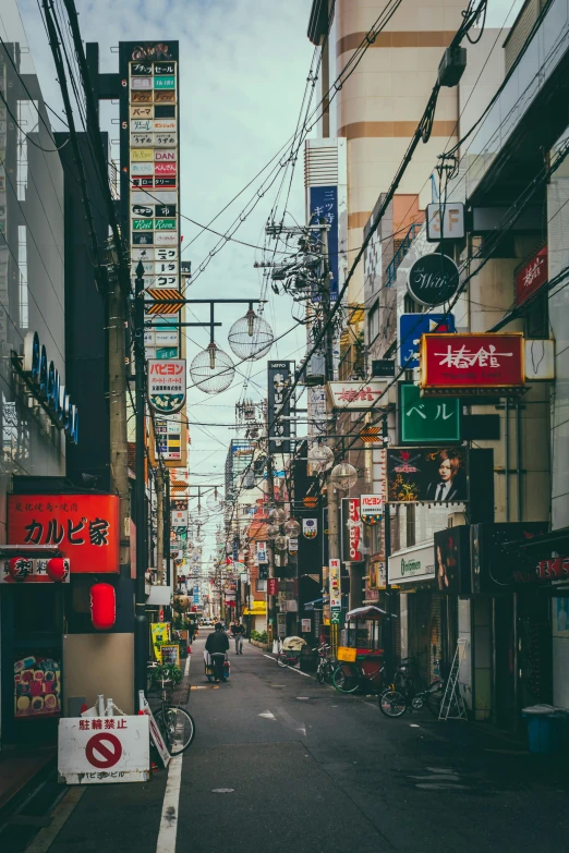 a person riding a motorcycle down an alley way