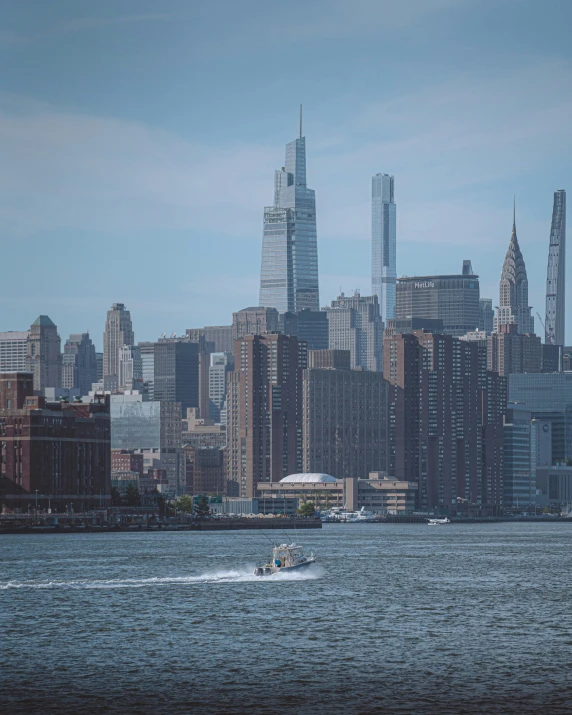 a boat in the water and a city skyline