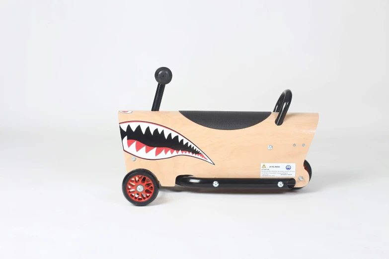 a wooden toy vehicle with shark - toothed teeth