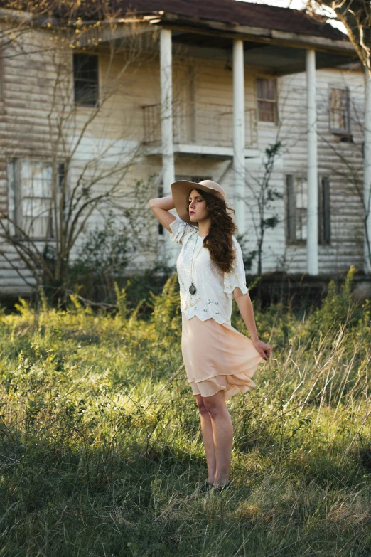 a woman wearing a hat in a field