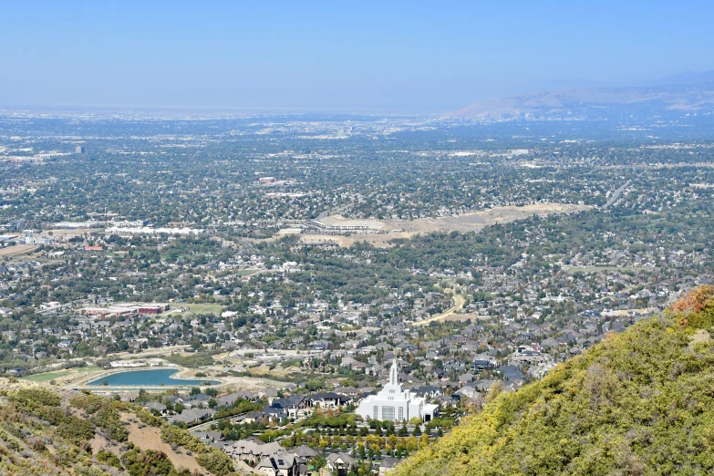 the view from a hill overlooking a city with a lake