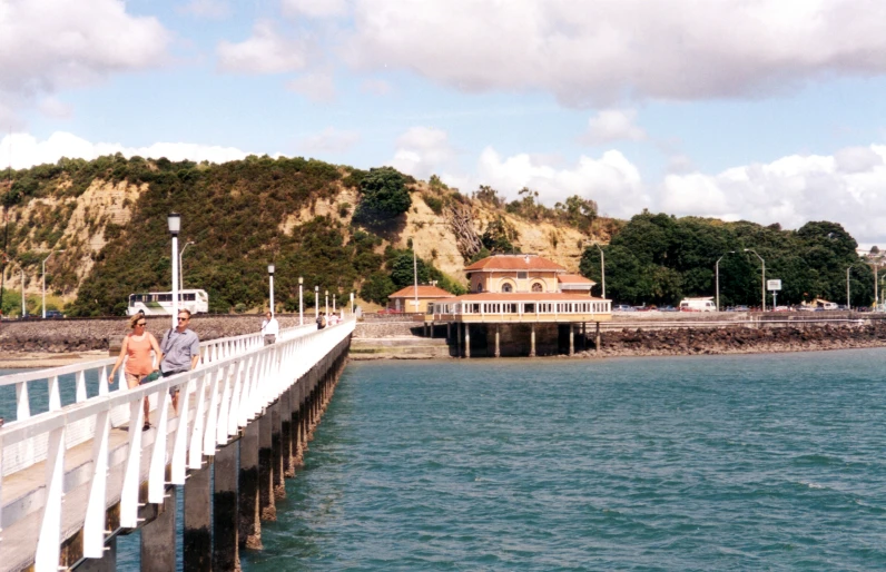 a person walking along a pier over the water