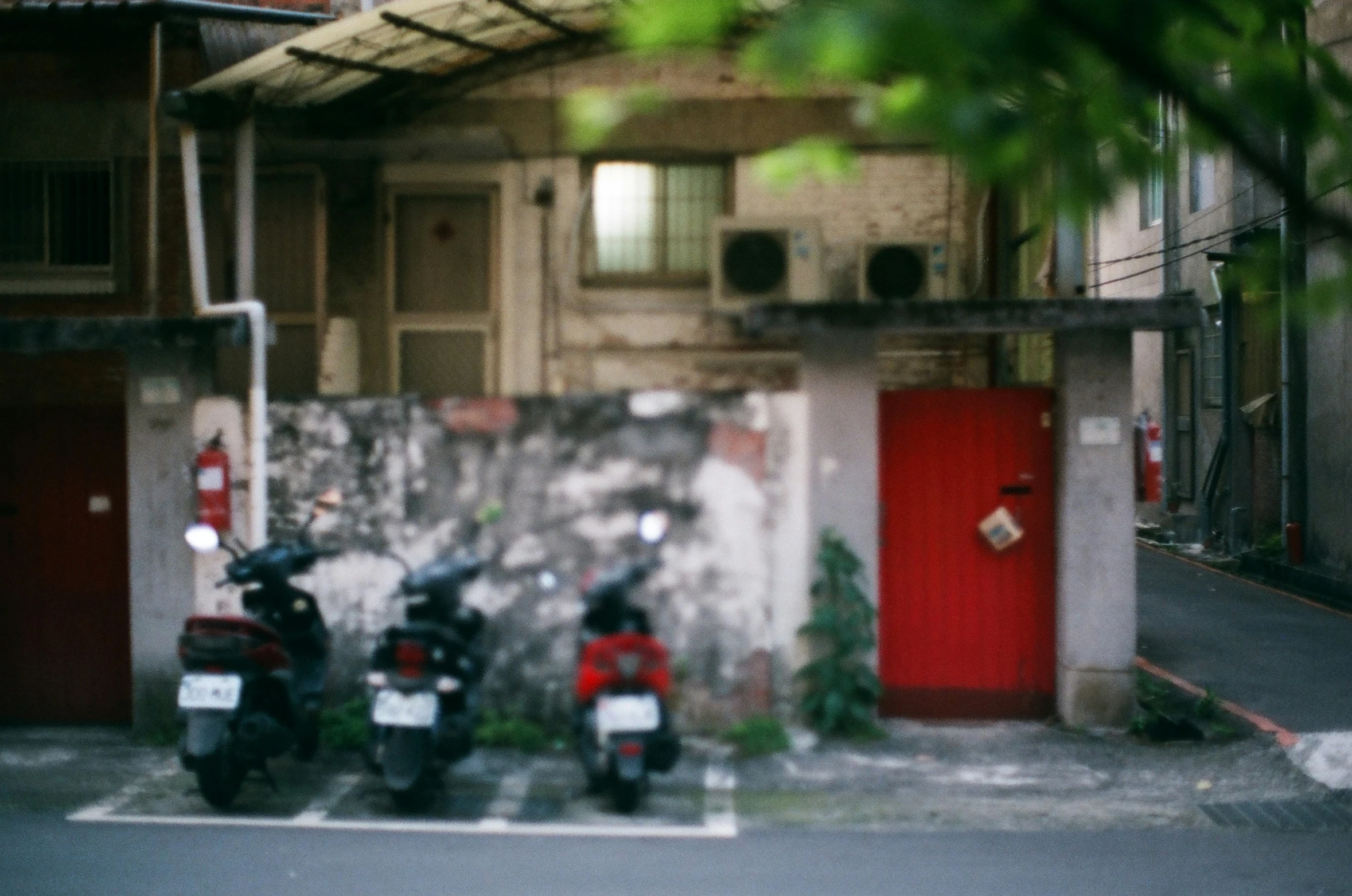 three scooters parked next to each other outside of a house