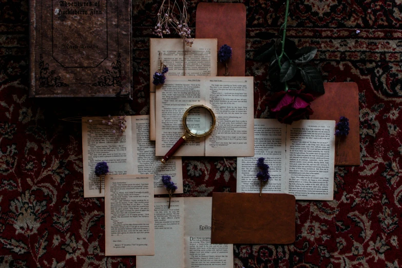 an old book laying on a colorful rug with a magnifying glass