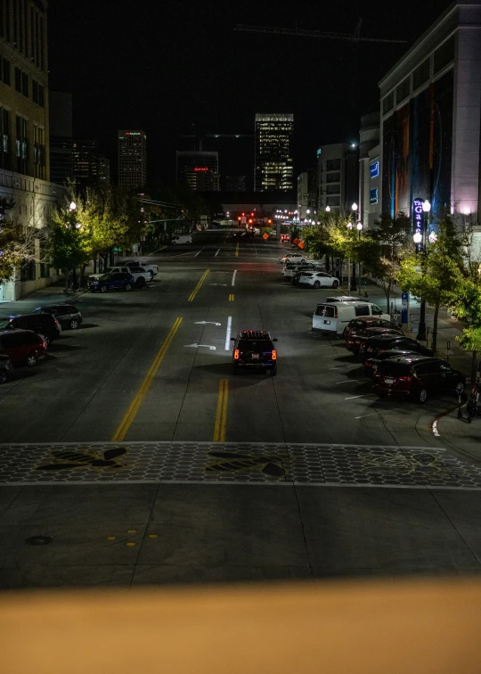 the city street is deserted at night for pedestrians to ride