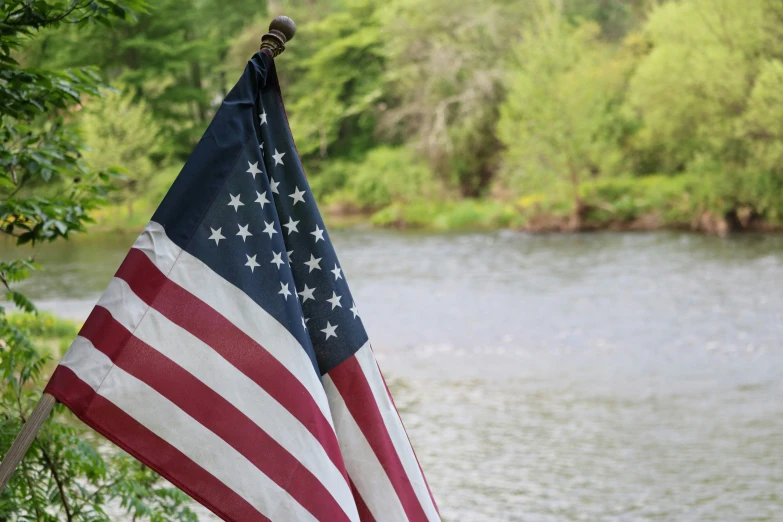 the flag is sitting next to some water