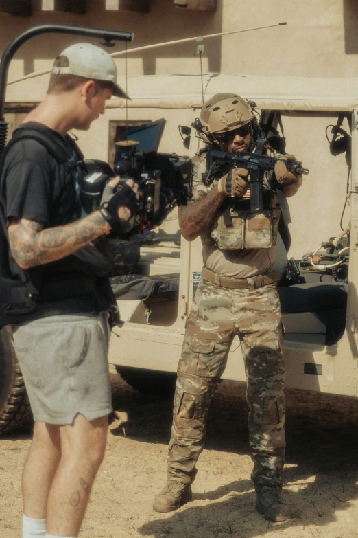 an army soldier shooting another person in front of his vehicle