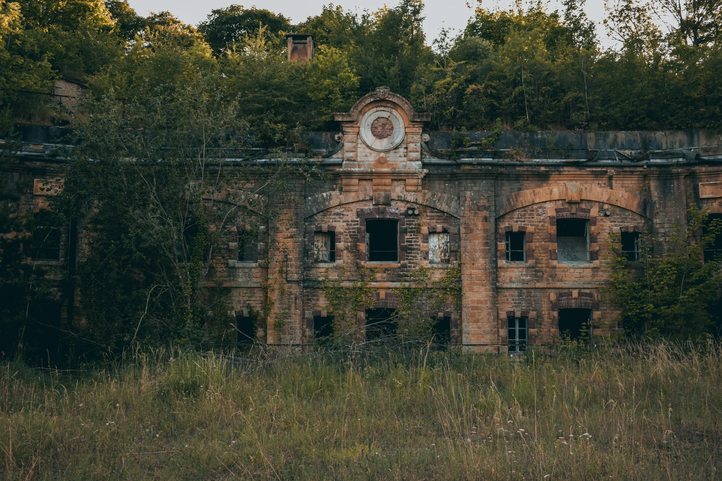 the large building is near many trees and bushes