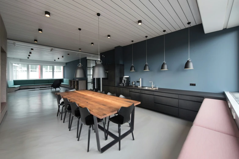 a modern looking room with black cabinets and pink seating area