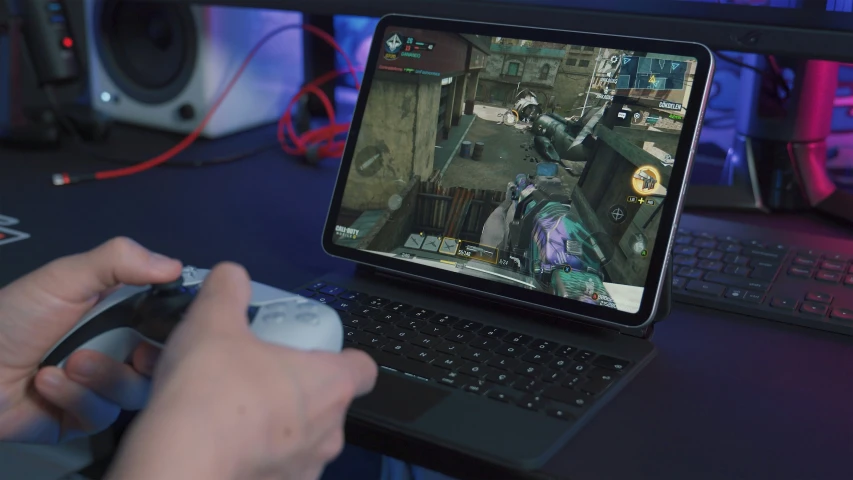 someone is playing on a laptop that can also be used for video games