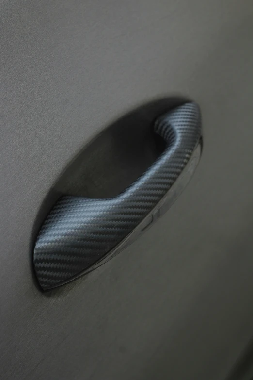 the closeup of a door handle of a sports car