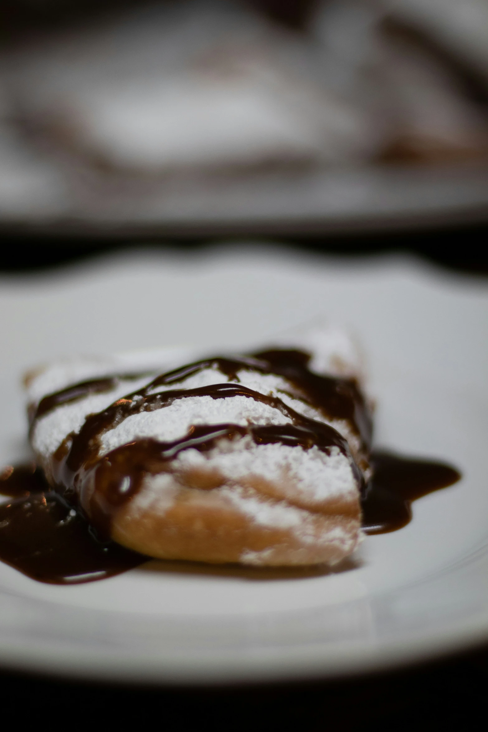 a dessert on a plate is covered in chocolate