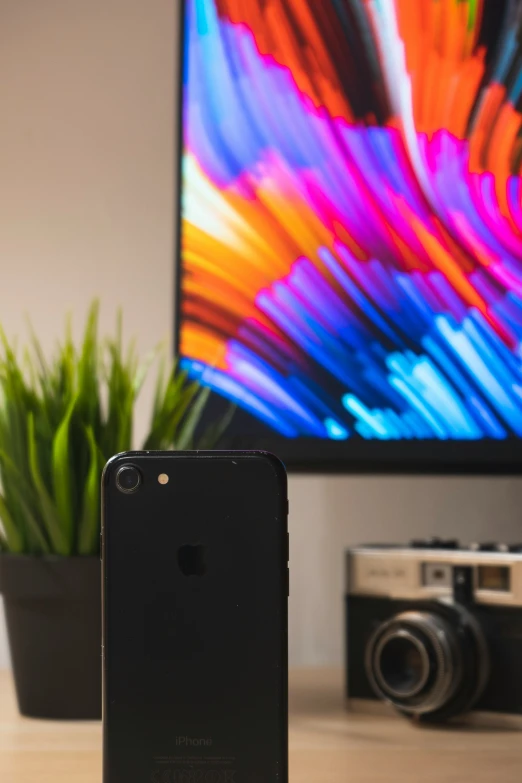 a picture of a camera with an iphone case and a tv screen