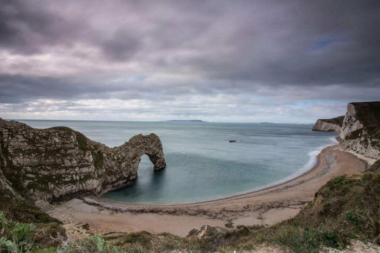 an aerial s of the famous durdle of rock formation at porth ran, wales