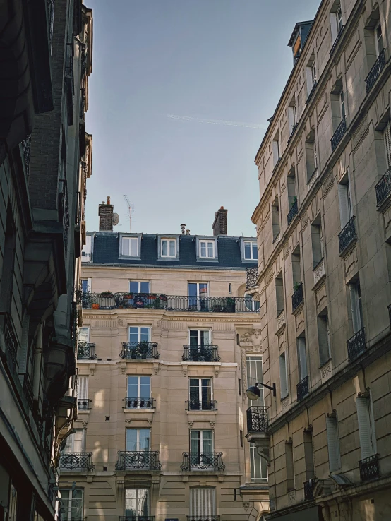 a view of a street in the middle of buildings from outside