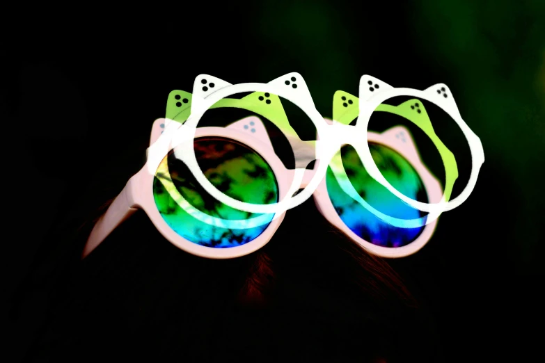 two white sunglasses and one blue and green