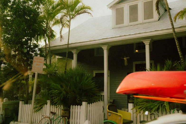 a car parked next to a house in the tropical