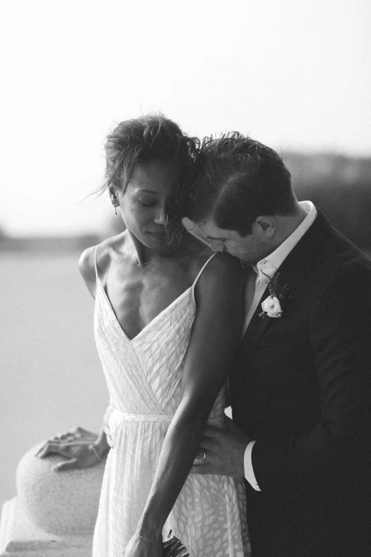 a couple that is kissing each other on the beach