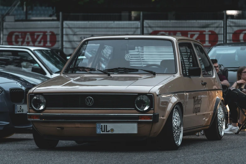 an old brown volkswagen in a parking lot