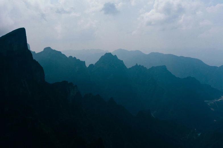 a very large mountain with clouds in the sky