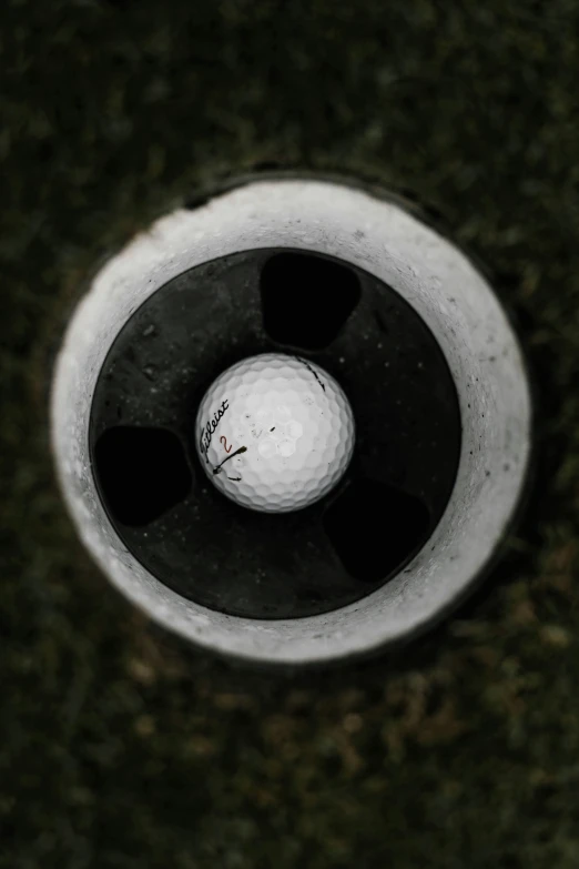 a golf ball with one end in the hole