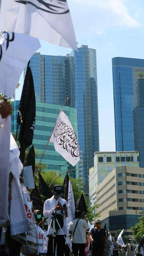 a man holding a flag with writing on it