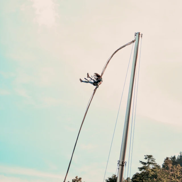 someone hanging off the side of a tower with a rope