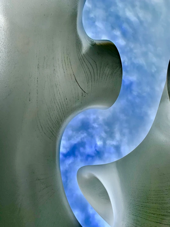 clouds and blue sky seen from below and inside a sand sculpture