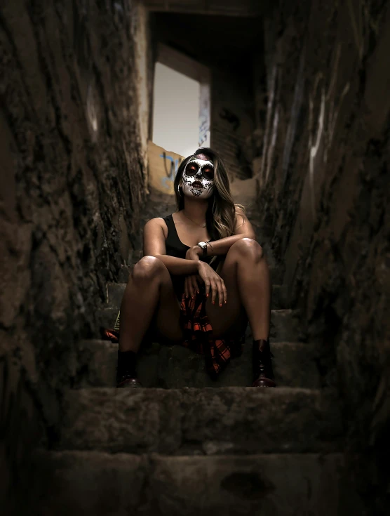 a woman sitting on stairs in a stone stairway