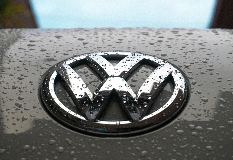 the emblem on a volkswagen car in the rain