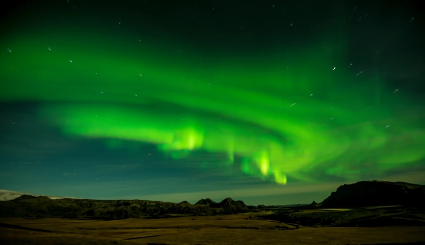 a green and purple aurora bore in the sky