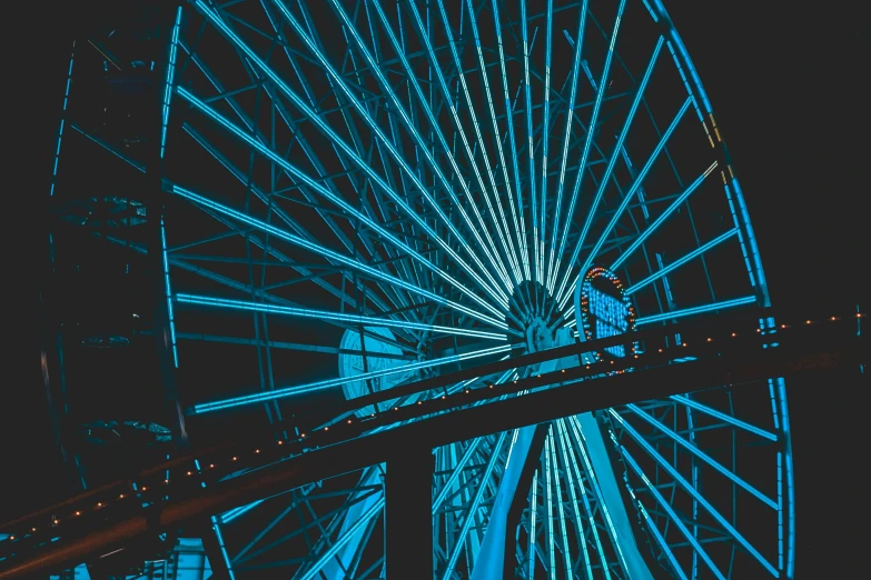 a man stands on a walkway with ferris wheel in the background