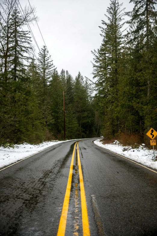 an empty road with some yellow line on it