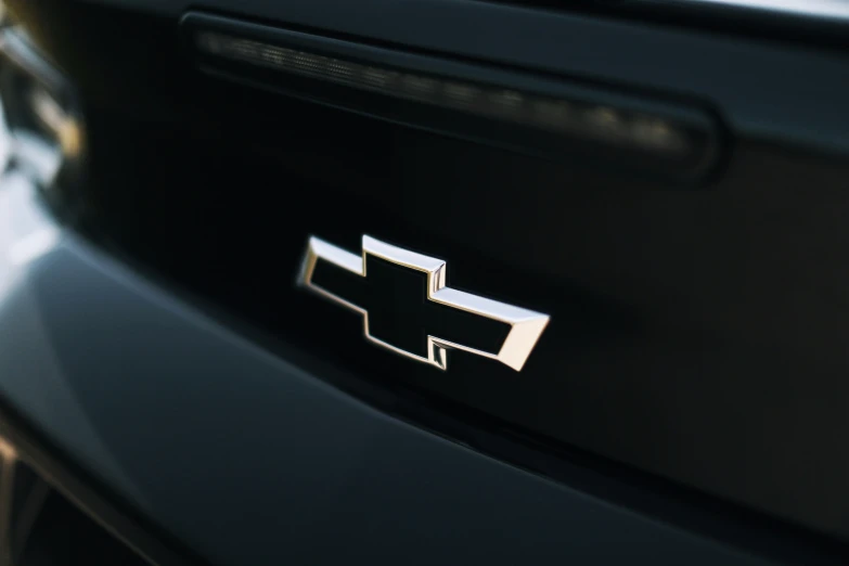 a silver emblem on the side of a black car