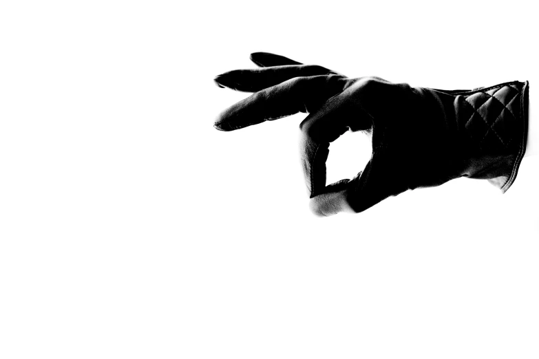 the black and white image of a hand reaching into the air