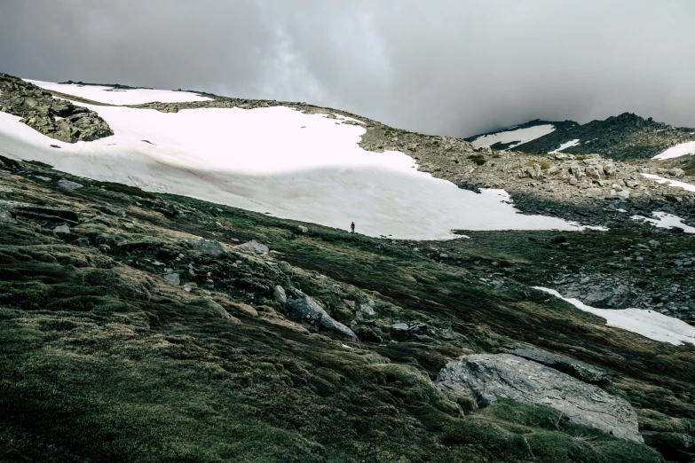 a person walking along a snow covered hillside