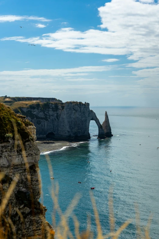 sea cliff and rock formations with water below them