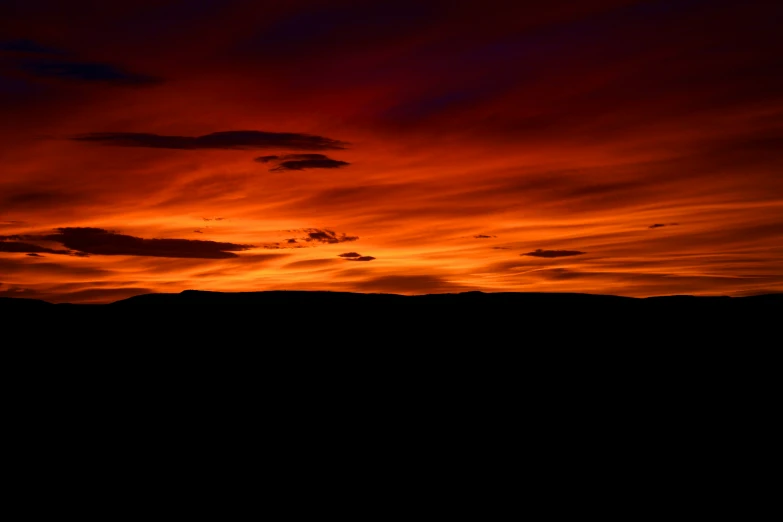 a plane is sitting in the sky at sunset