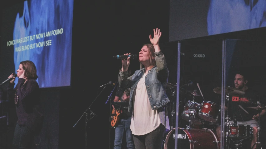 two women and one is singing with a microphone