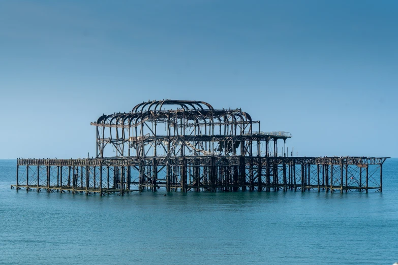 an abandoned structure sitting out in the middle of the water