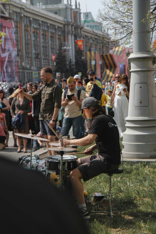 a group of people standing around with drums