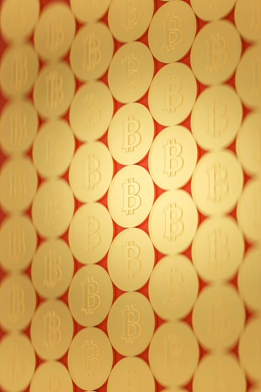 close up of gold colored currency with bitcoins on them