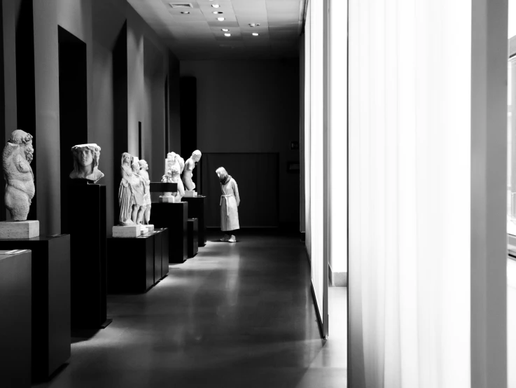 many large and small statues in an empty room
