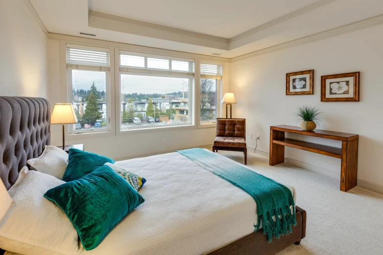 a large bedroom with high ceilings and a view