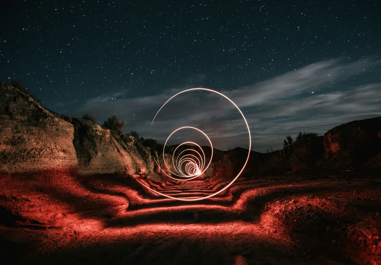 the light trails of a single object are captured in a night time sky