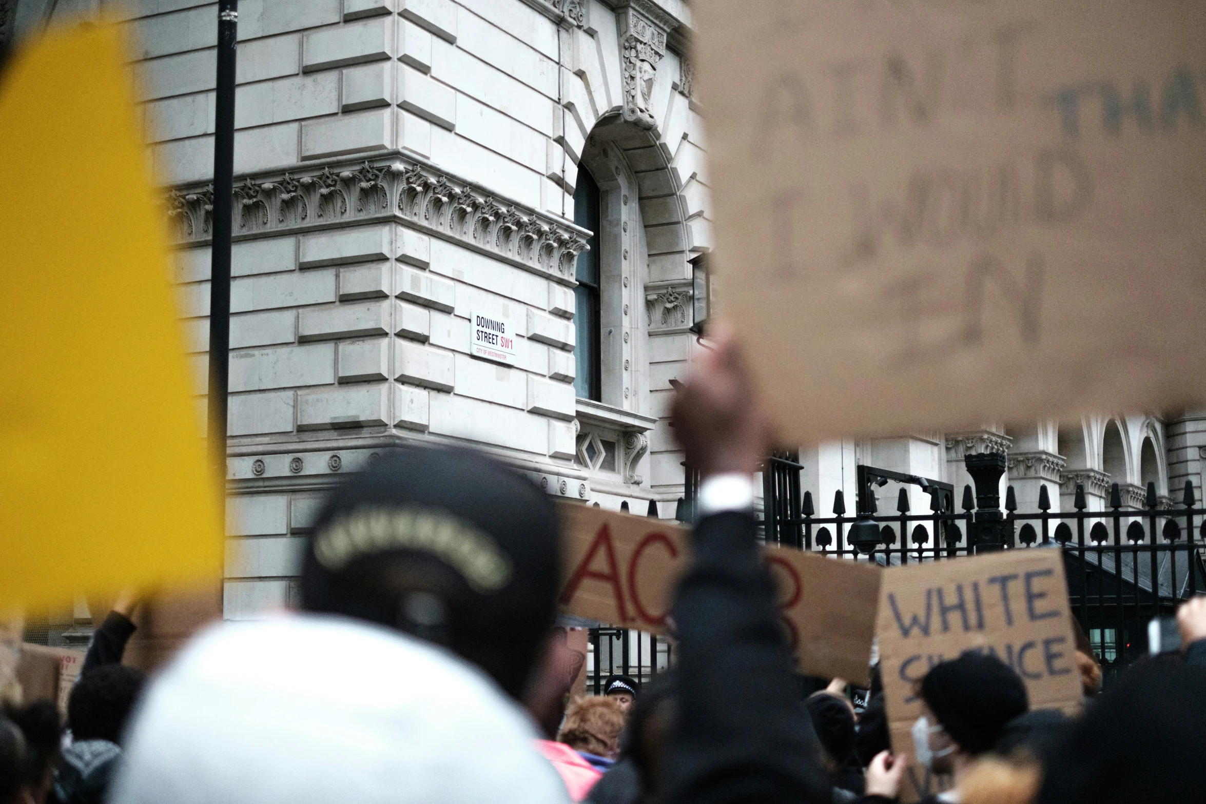 large group of protesters gathered in front of a white house