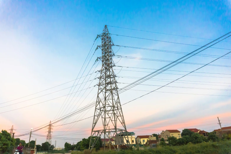 a power tower sitting next to a bunch of houses