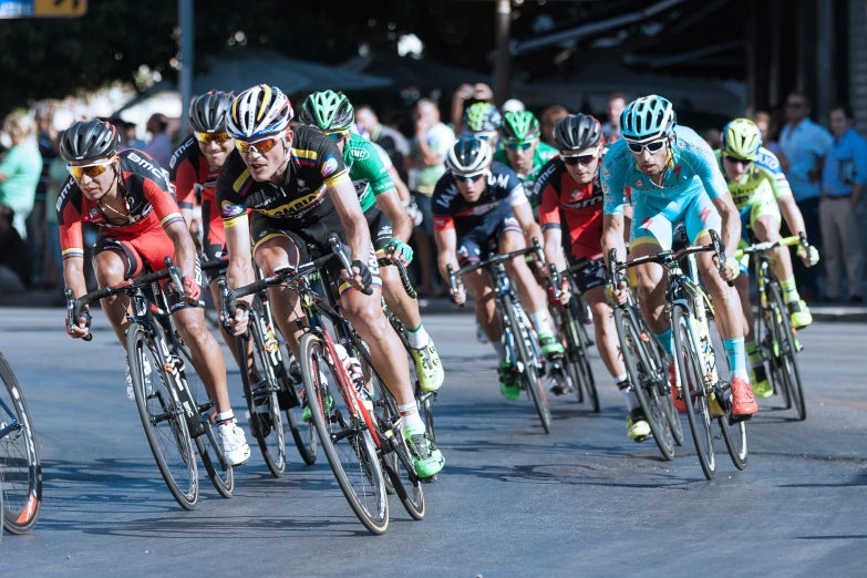 a group of bicyclists racing down a race course