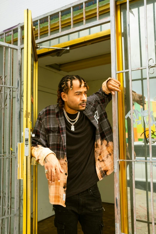 a young man getting his hands out of the metal doors