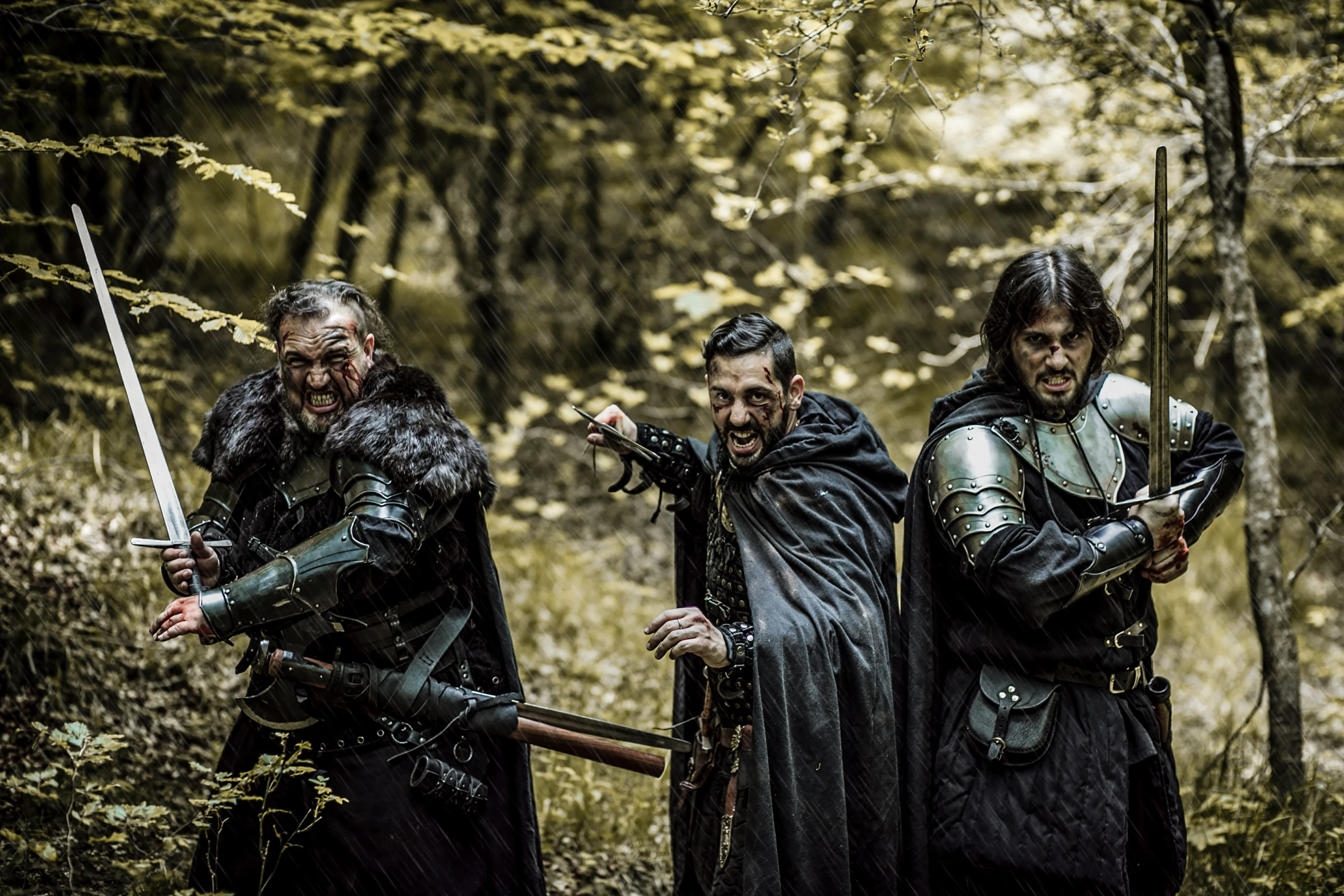 a group of men in gothic clothing holding swords